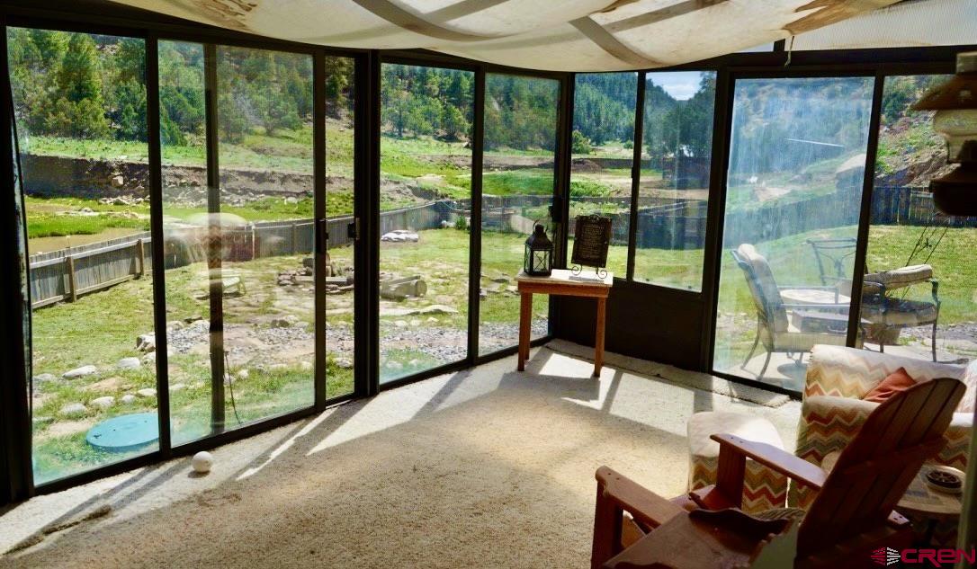 955 County Road 303, Unit CROSS CANYON RANCH Cebolla, NM 87518 - Photo 22 of 44 a work room with large glass windows