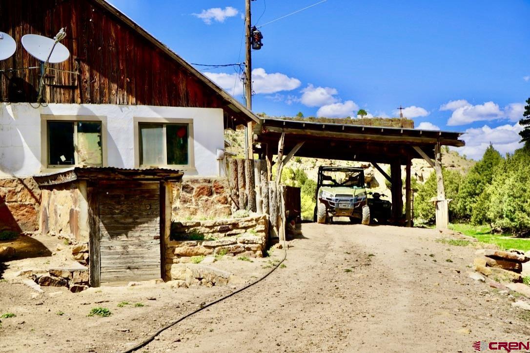 955 County Road 303, Unit CROSS CANYON RANCH Cebolla, NM 87518 - Photo 24 of 44 a view of a patio with table and chairs