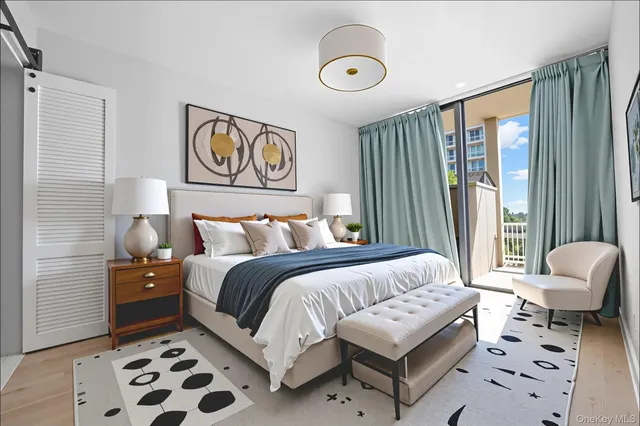 a bedroom with a bed couch and a window