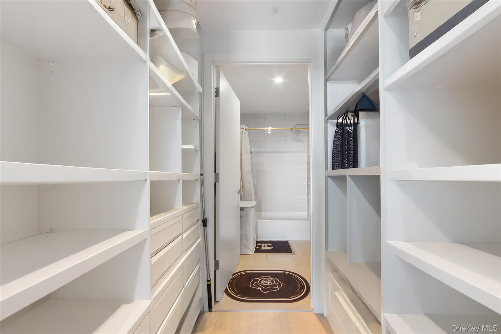 131-02 40th Road, Unit 12G Queens, NY 11354 - Photo 13 of 18 a bathroom with a sink and a washer dryer