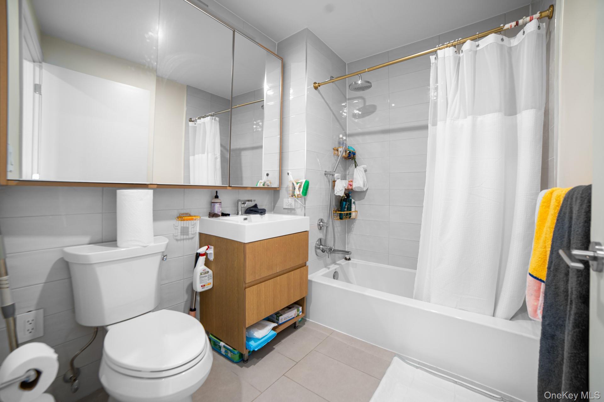 131-02 40th Road, Unit 12G Queens, NY 11354 - Photo 17 of 18 a bathroom with a sink toilet and shower