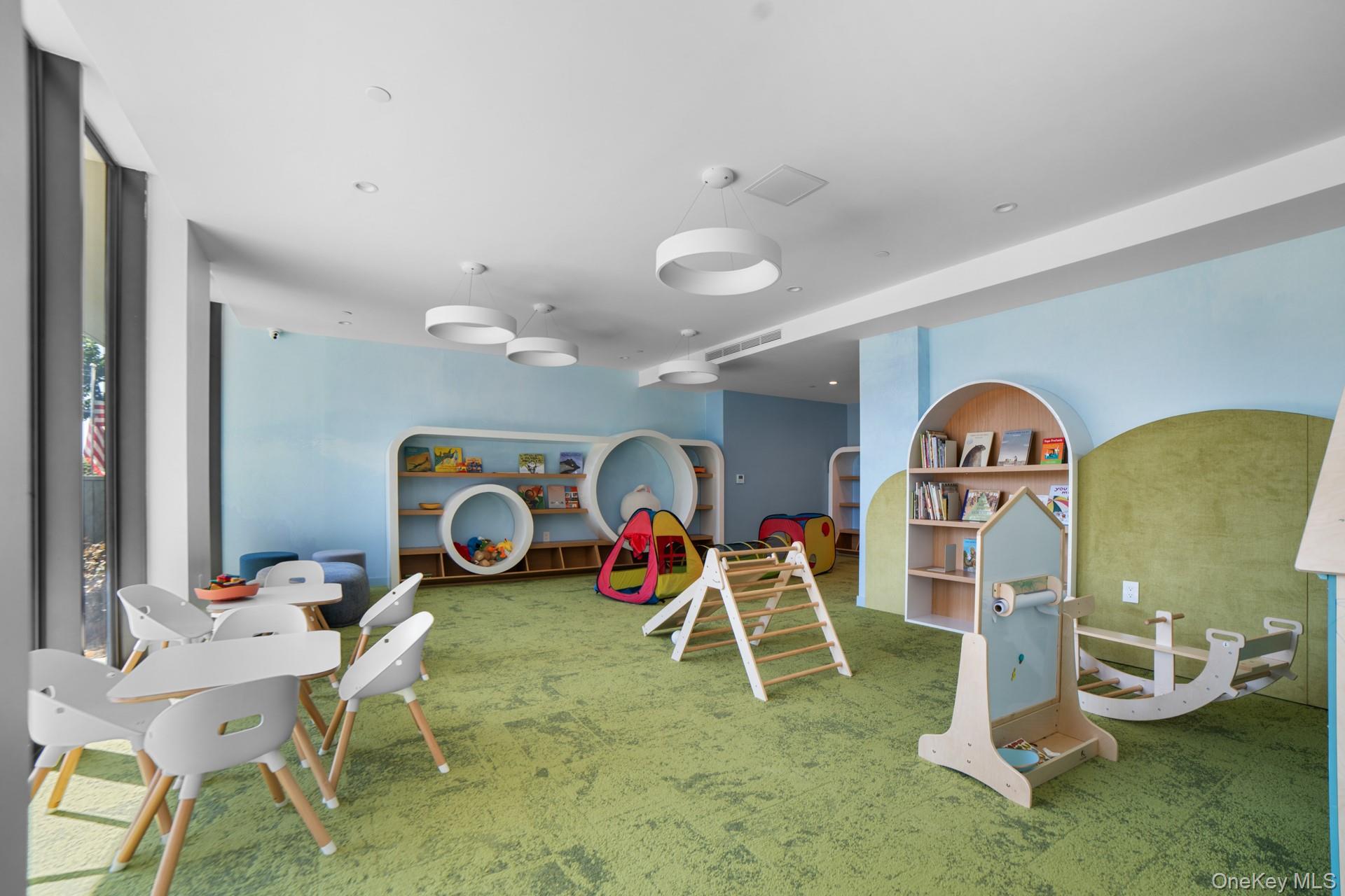 131-02 40th Road, Unit 12G Queens, NY 11354 - Photo 3 of 18 a living room with furniture a table and kitchen view