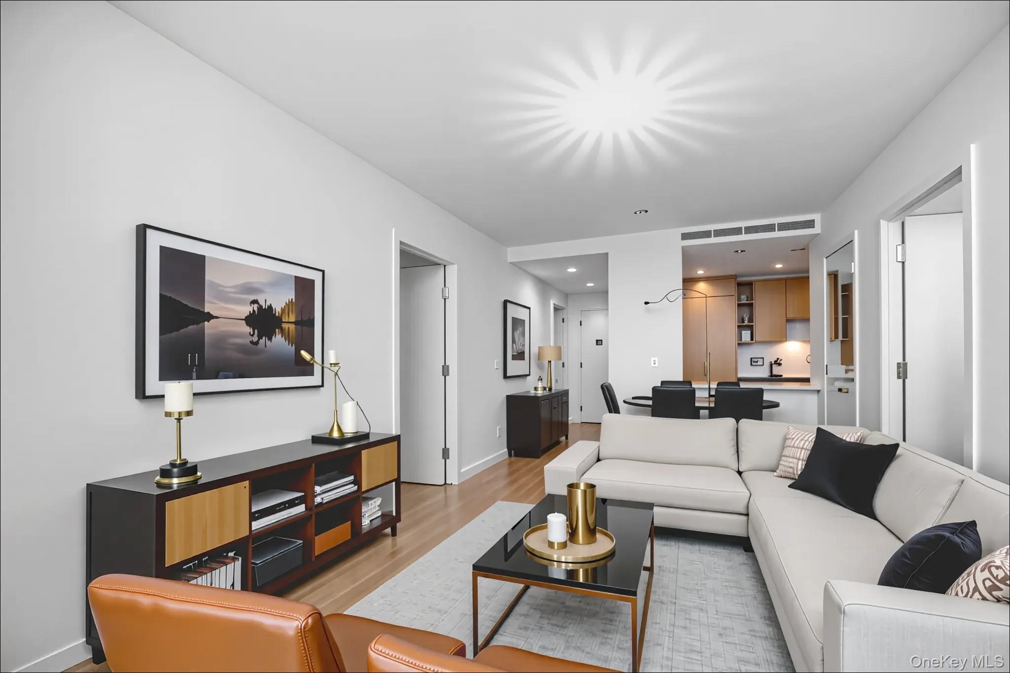 131-02 40th Road, Unit 12G Queens, NY 11354 - Photo 8 of 18 a living room with furniture and a chandelier