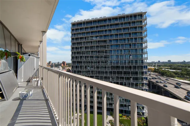 a view of a balcony with wooden floor and fence