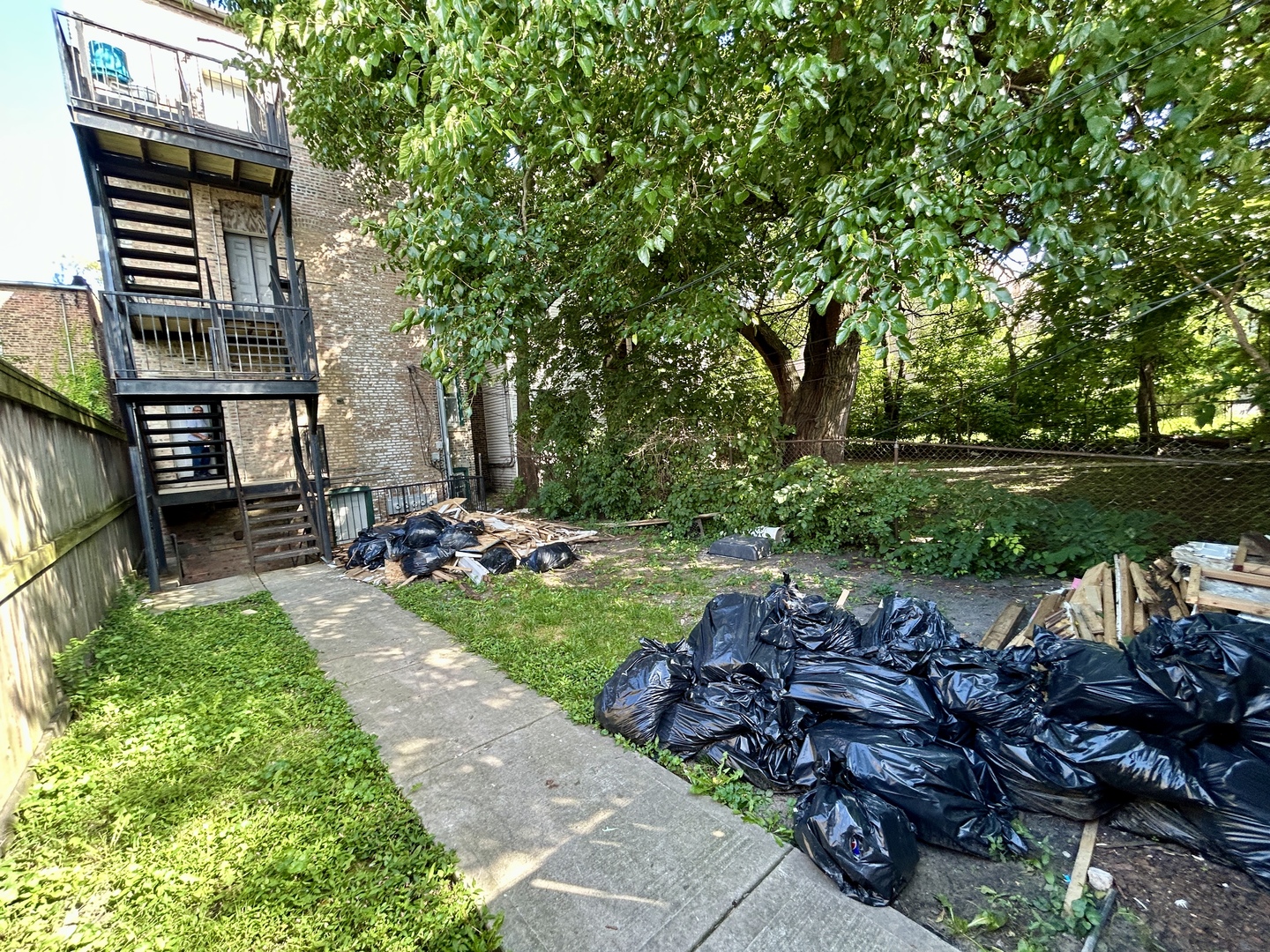 5714 South Prairie Avenue Chicago, IL 60637 - Photo 37 of 39 a view of a backyard with table and chairs plants and trees