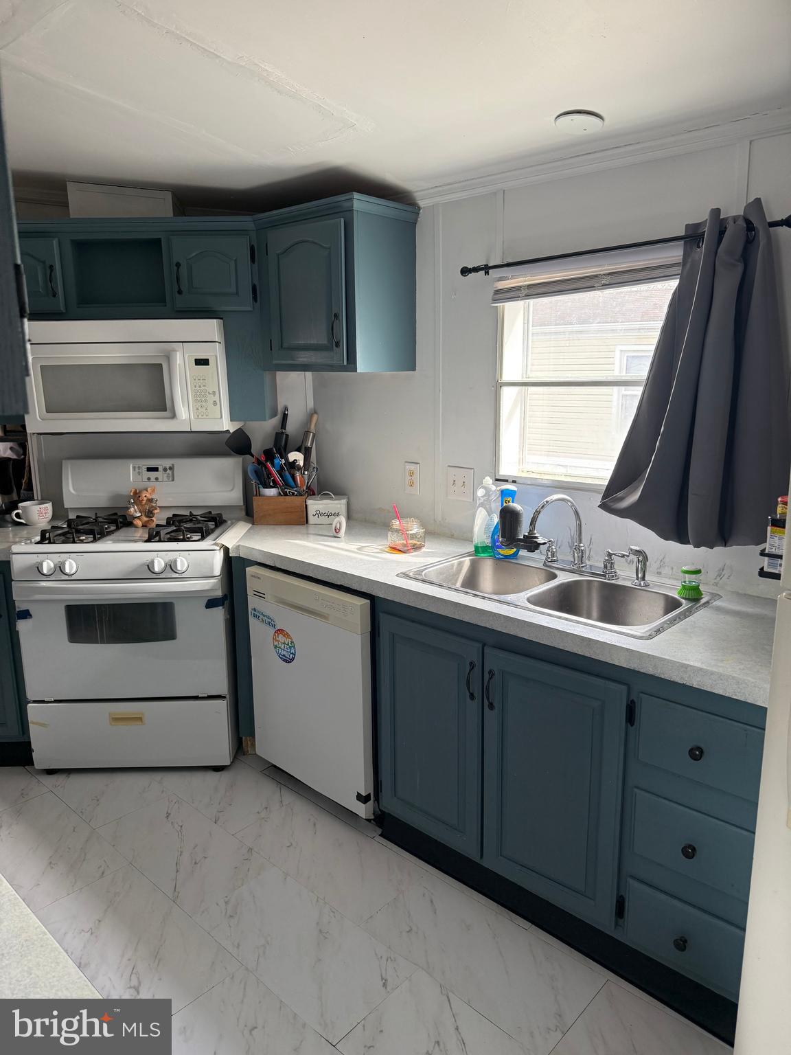 938 Decoy Way, Unit A161 Bear, DE 19701 - Photo 9 of 17 a kitchen with a sink stove and cabinets