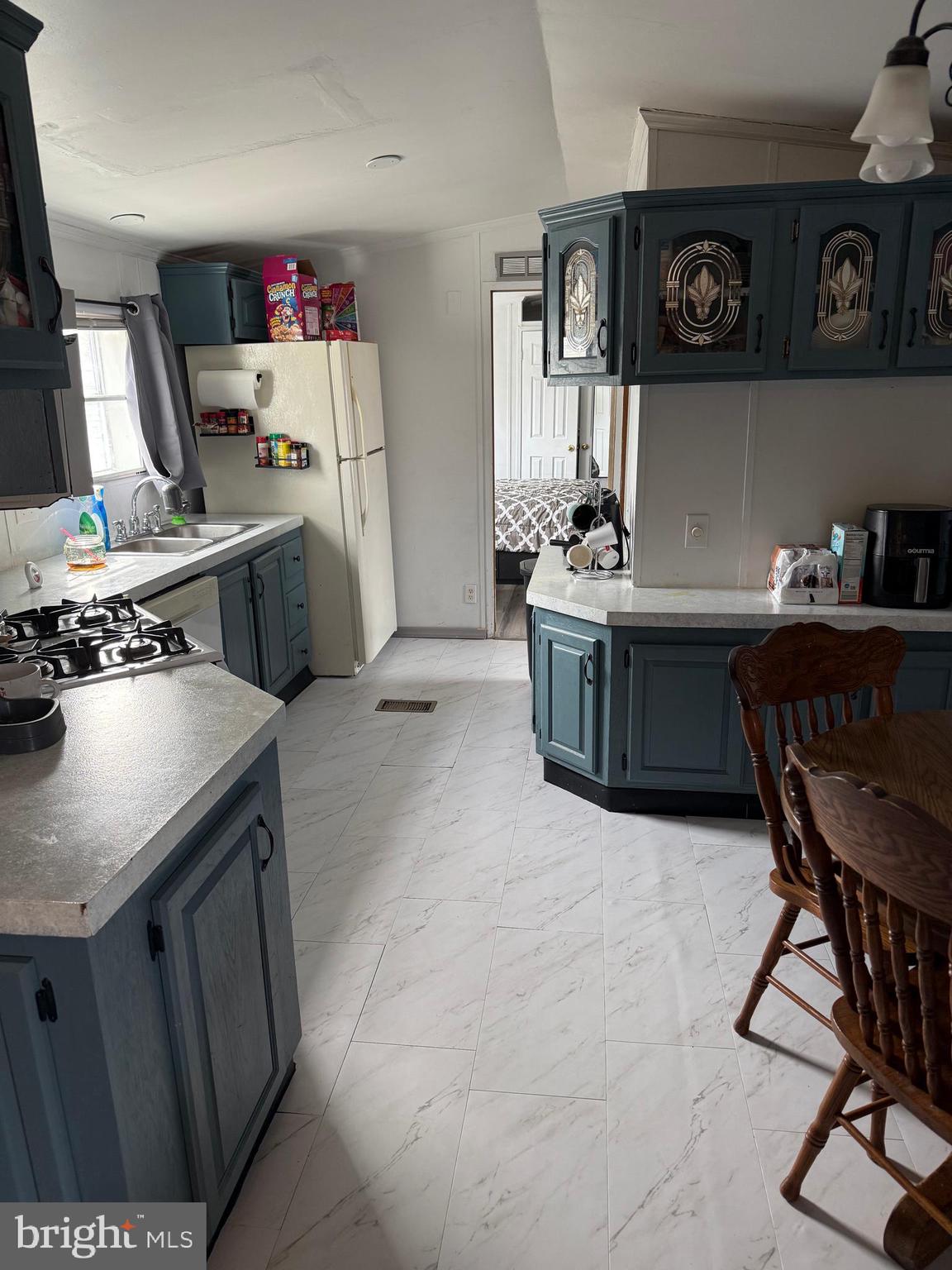 938 Decoy Way, Unit A161 Bear, DE 19701 - Photo 10 of 17 a kitchen with stainless steel appliances a stove a sink cabinets and a refrigerator