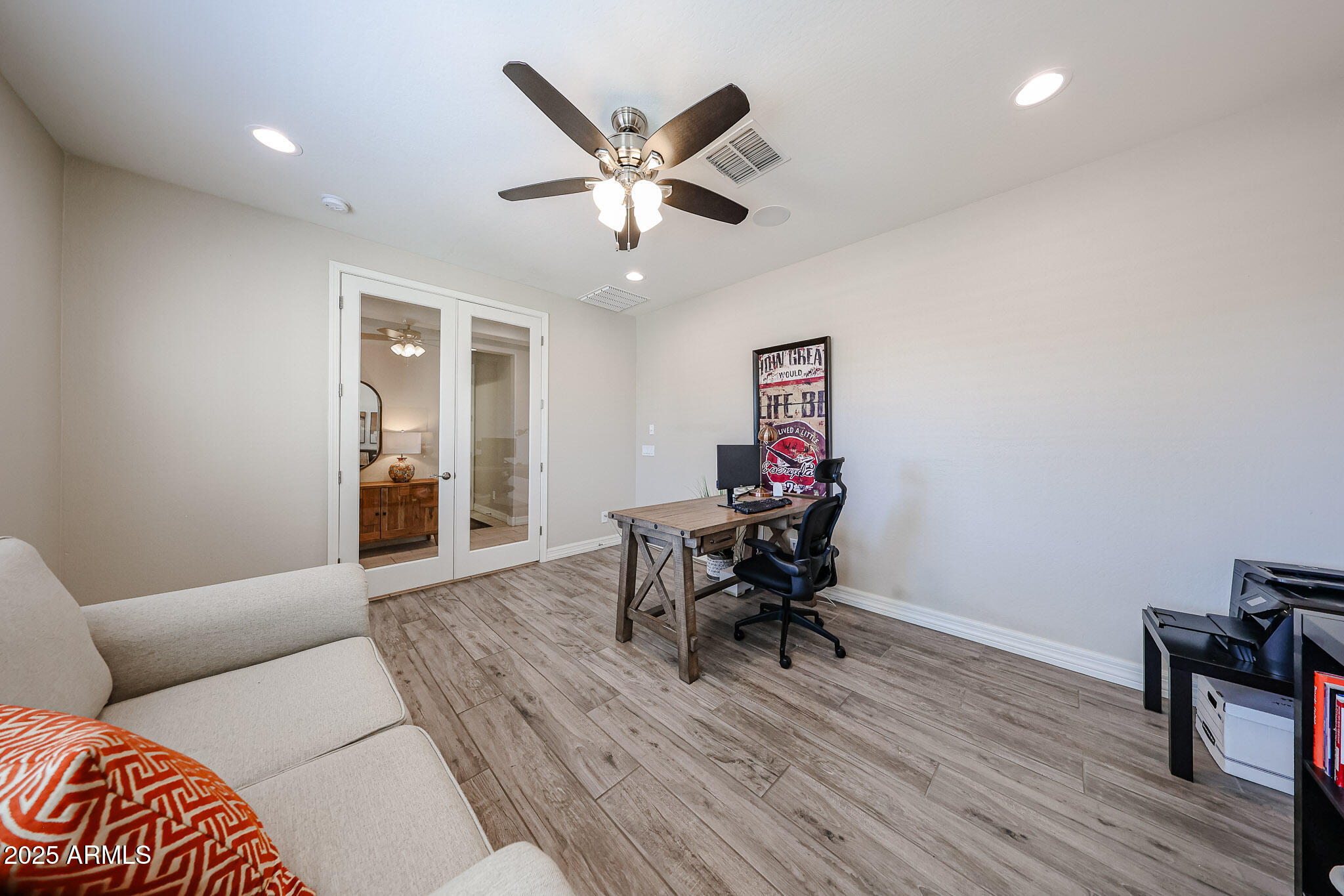 18184 West Deer Creek Road Goodyear, AZ 85338 - Photo 11 of 82 a living room with furniture and a wooden floor