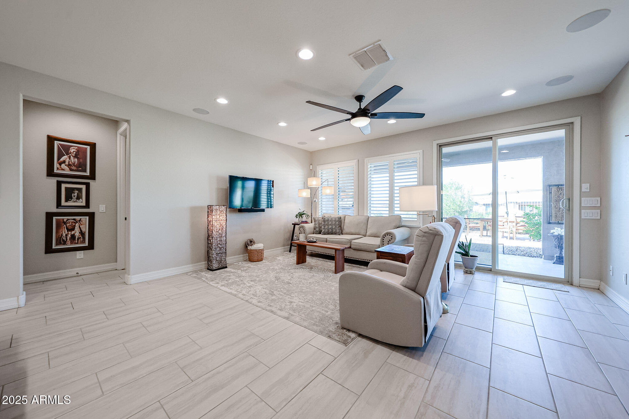 18184 West Deer Creek Road Goodyear, AZ 85338 - Photo 25 of 82 a living room with furniture and large windows