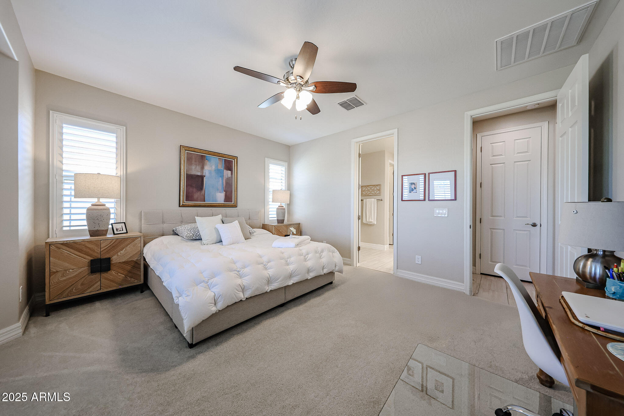 18184 West Deer Creek Road Goodyear, AZ 85338 - Photo 30 of 82 a bedroom with a bed and a couch