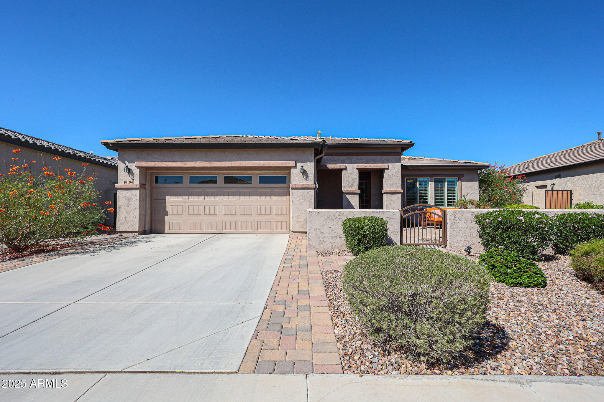 18184 West Deer Creek Road Goodyear, AZ 85338 - Photo 3 of 82 a front view of a house with a yard and garage