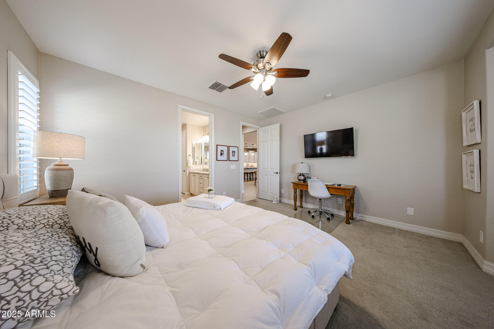 18184 West Deer Creek Road Goodyear, AZ 85338 - Photo 31 of 82 a bedroom with a bed window and a flat screen tv
