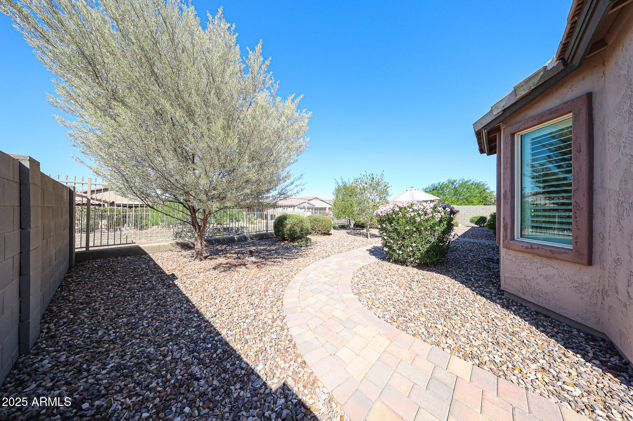 18184 West Deer Creek Road Goodyear, AZ 85338 - Photo 48 of 82 a view of a backyard with pathway