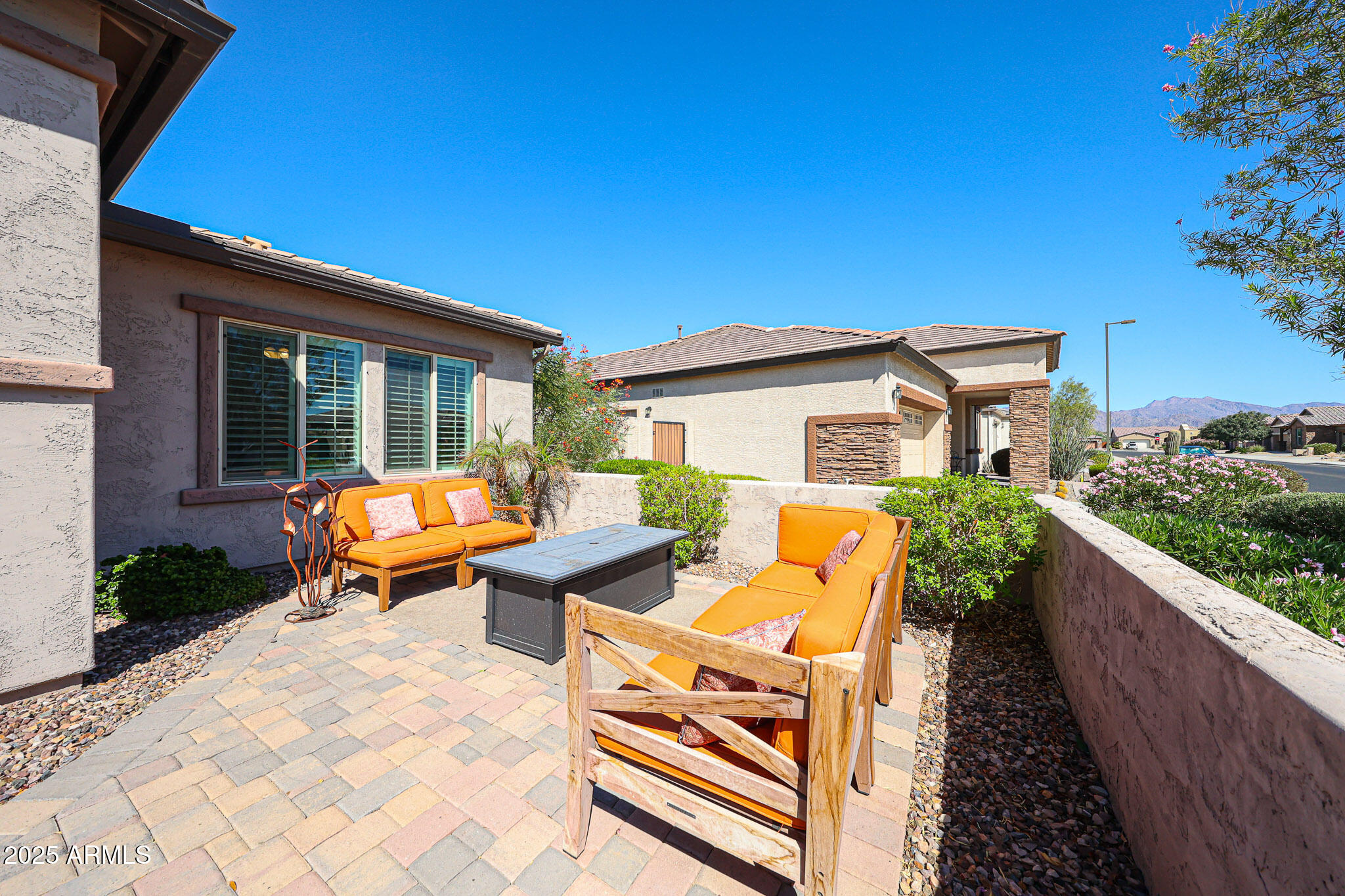 18184 West Deer Creek Road Goodyear, AZ 85338 - Photo 6 of 82 a balcony with table and chairs with wooden fence