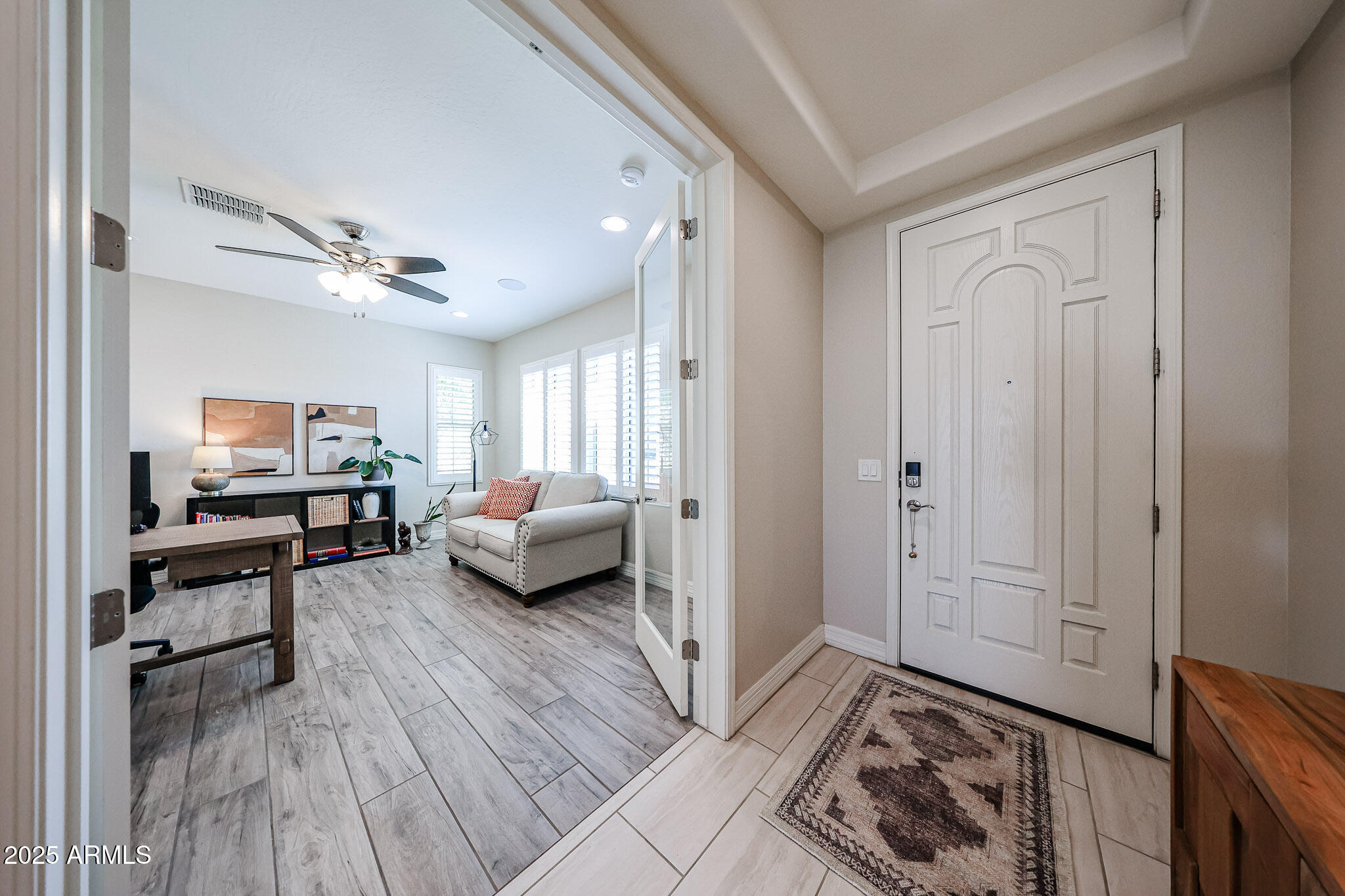 18184 West Deer Creek Road Goodyear, AZ 85338 - Photo 8 of 82 a living room with furniture and a wooden floor