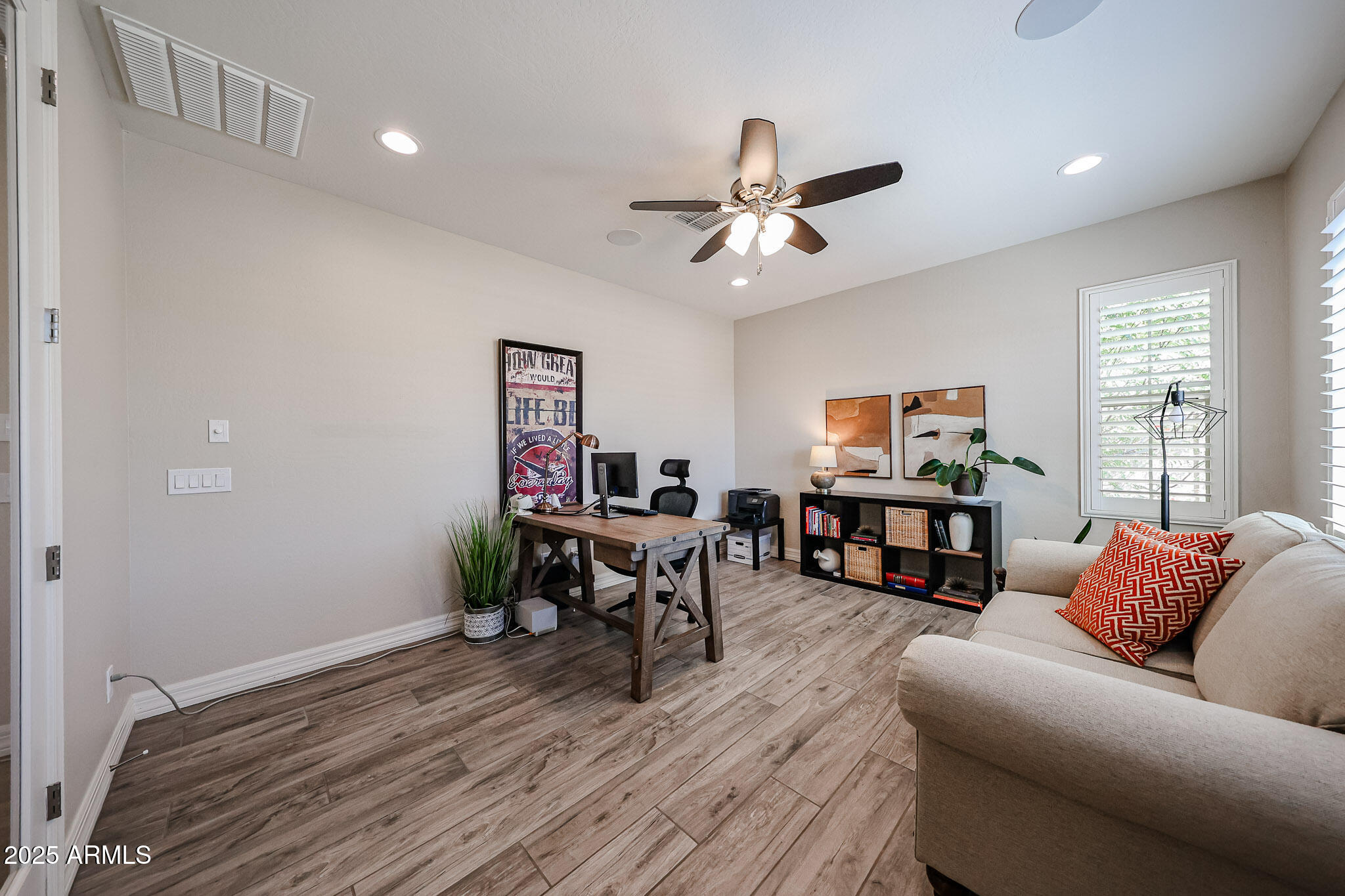 18184 West Deer Creek Road Goodyear, AZ 85338 - Photo 10 of 82 a living room with furniture and a wooden floor