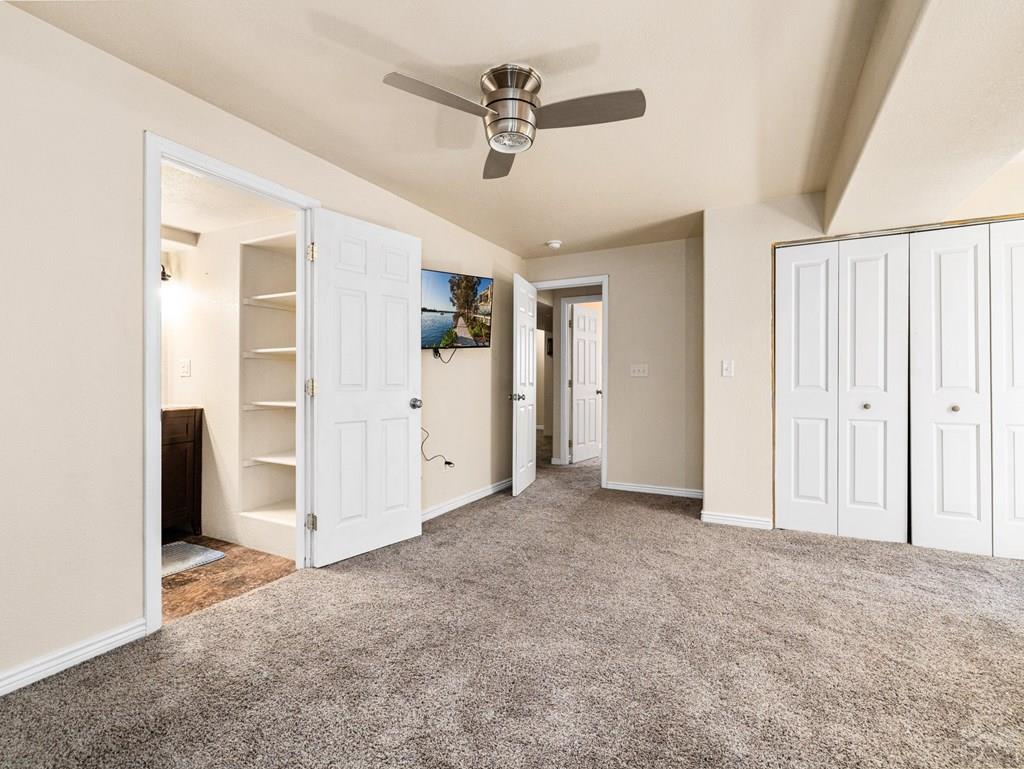 43948 Hunsaker Road Avondale, CO 81022 - Photo 36 of 56 an empty room with closet and a ceiling fan