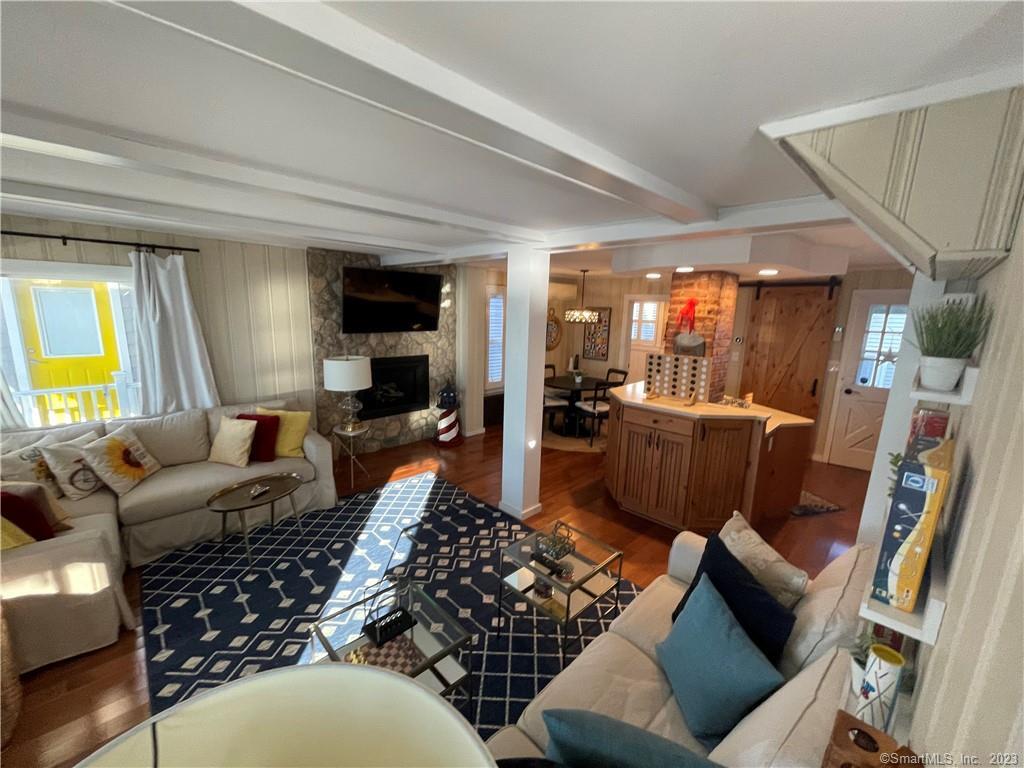 59 Melba Street Milford, CT 06460 - Photo 12 of 38 a living room with furniture and a wooden floor