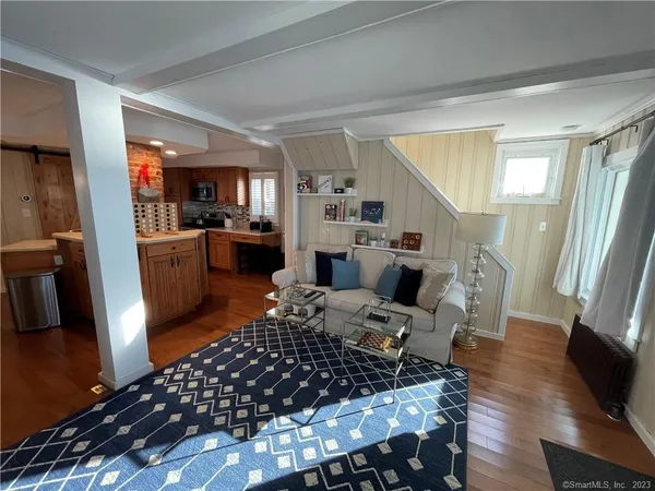 a living room with furniture fireplace and a large window