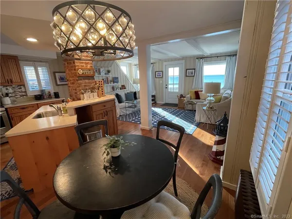 a view of a dining room with furniture and chandelier