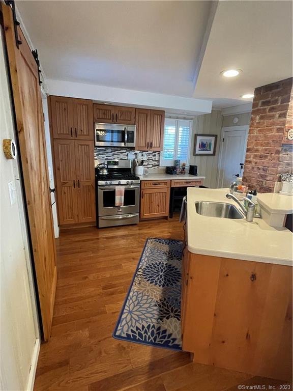 59 Melba Street Milford, CT 06460 - Photo 22 of 38 a kitchen with stainless steel appliances granite countertop a refrigerator stove oven and sink