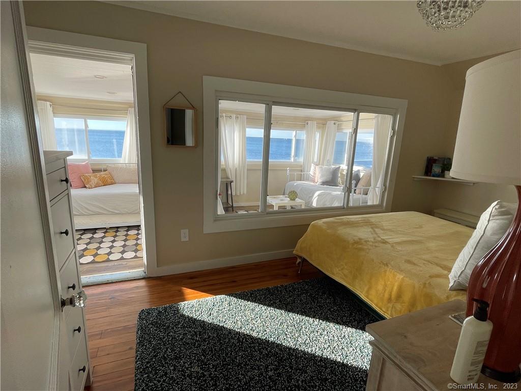 59 Melba Street Milford, CT 06460 - Photo 25 of 38 a bedroom with a bed and wooden floor