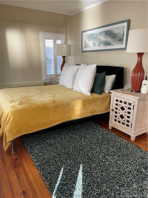 59 Melba Street Milford, CT 06460 - Photo 27 of 38 a bedroom with a bed and wooden floor