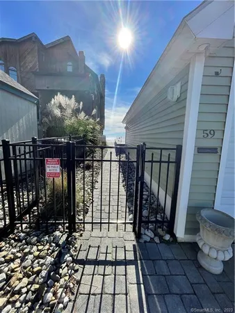 a view of a pathway with a wrought fence