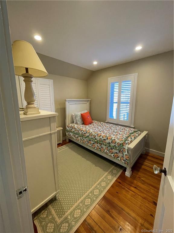 59 Melba Street Milford, CT 06460 - Photo 35 of 38 a bedroom with a bed and wooden floor