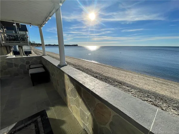 a terrace with wooden floor and outdoor seating