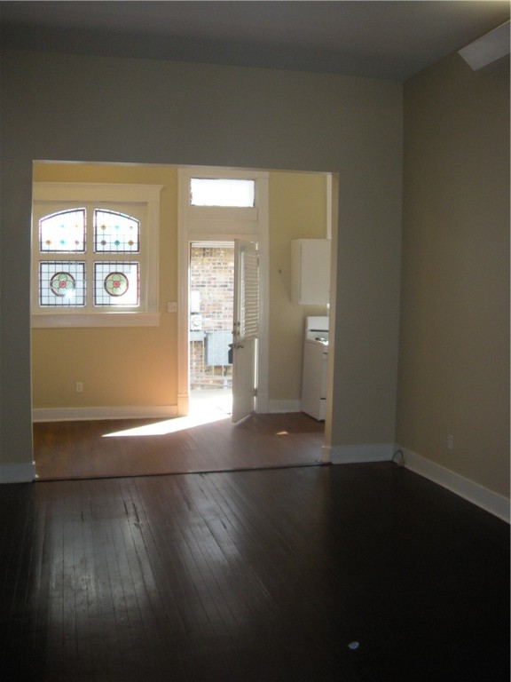 915 West 23rd Street, Unit C Austin, TX 78705 - Photo 12 of 22 an empty room with wooden floor and windows