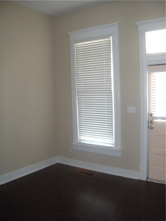 915 West 23rd Street, Unit C Austin, TX 78705 - Photo 17 of 22 a view of an empty room with wooden floor and a window