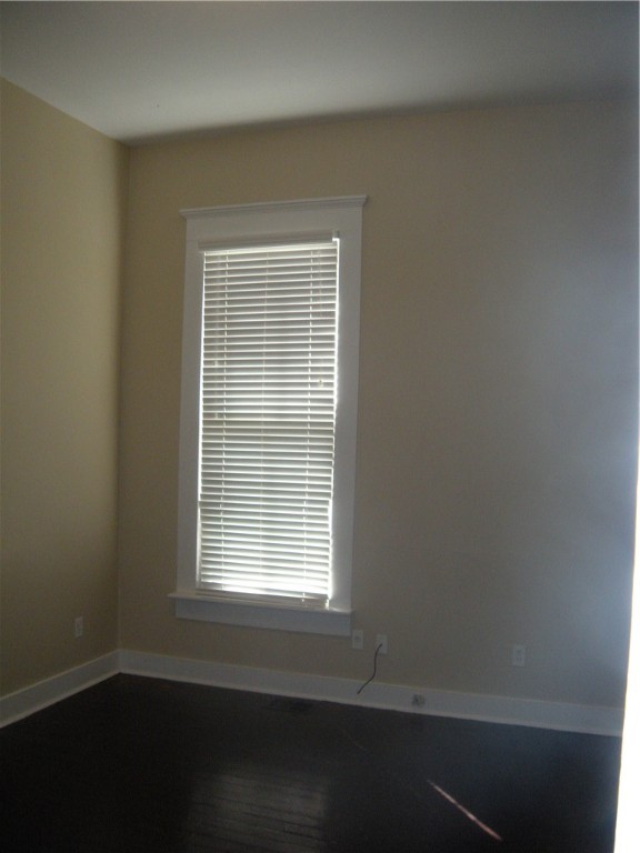 915 West 23rd Street, Unit C Austin, TX 78705 - Photo 20 of 22 a view of an empty room with wooden floor and a window