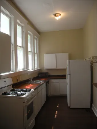 a kitchen with a stove and a refrigerator