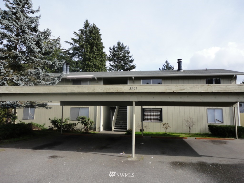 3901 Mason Loop Road Tacoma, WA 98409 - Photo 1 of 12 a front view of a house with lots of trees