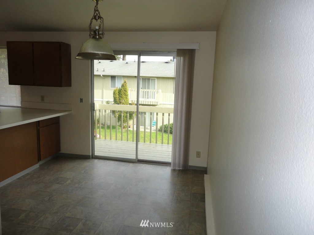 3901 Mason Loop Road Tacoma, WA 98409 - Photo 5 of 12 a view of an empty room with a window
