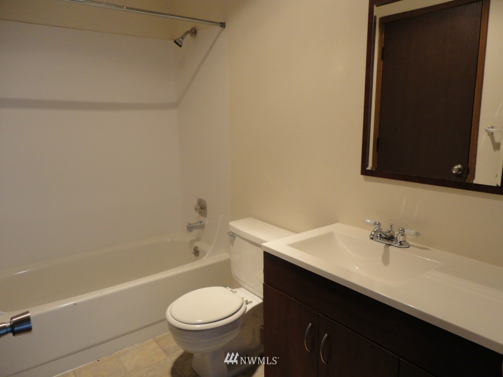 3901 Mason Loop Road Tacoma, WA 98409 - Photo 8 of 12 a bathroom with a sink toilet and shower