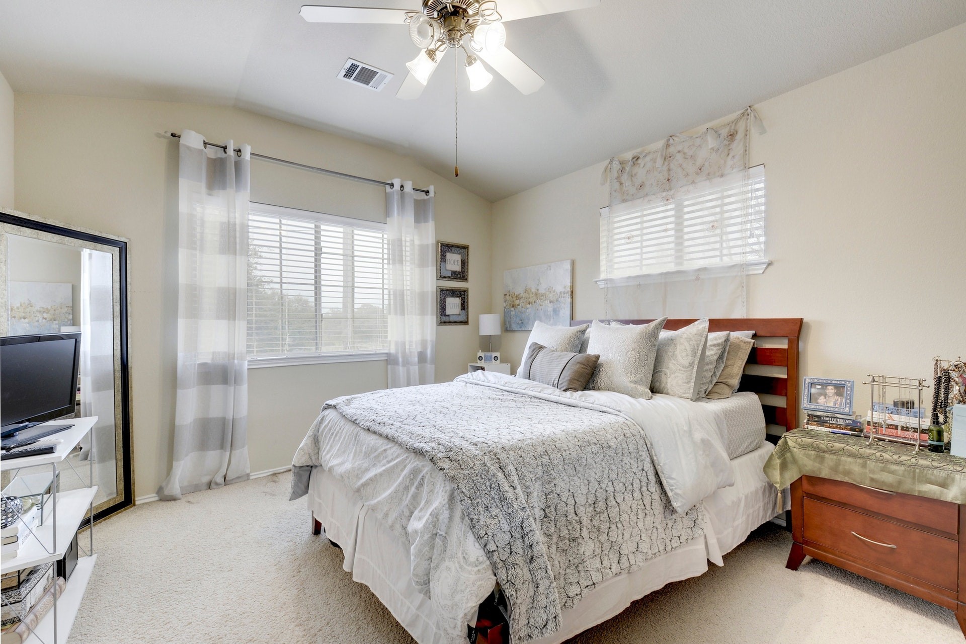 14815 Avery Ranch Boulevard, Unit 1103 Austin, TX 78717 - Photo 15 of 25 a bedroom with a bed and a flat tv screen on dresser