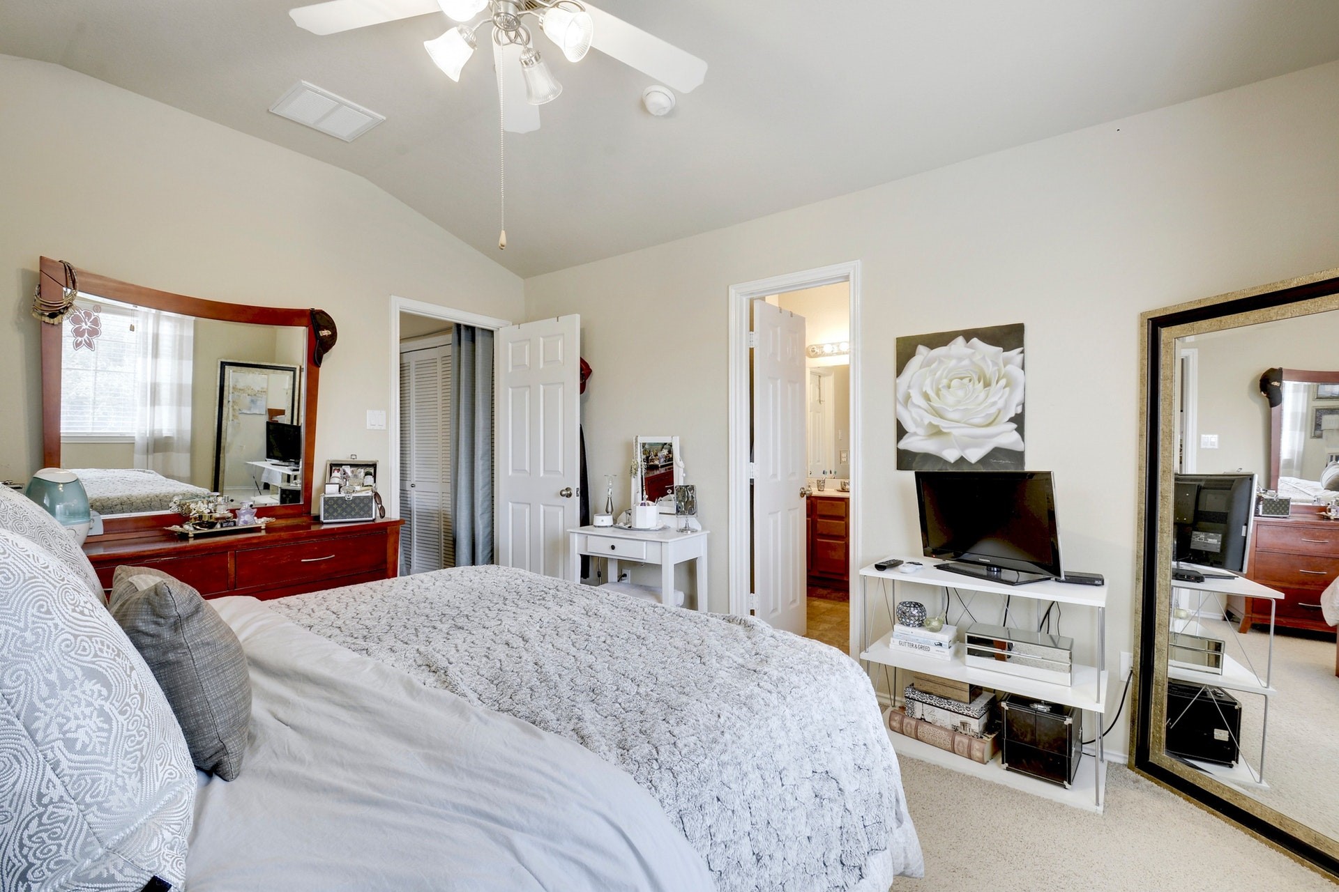 14815 Avery Ranch Boulevard, Unit 1103 Austin, TX 78717 - Photo 17 of 25 a bedroom with a bed and a flat tv screen on wall