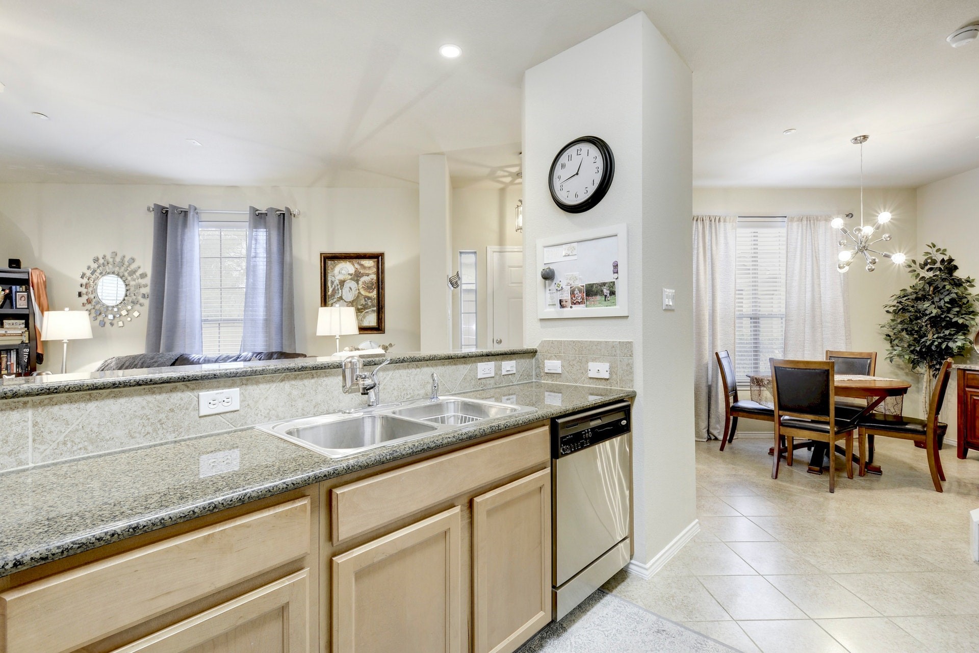 14815 Avery Ranch Boulevard, Unit 1103 Austin, TX 78717 - Photo 9 of 25 a kitchen with a sink and a clock on the wall