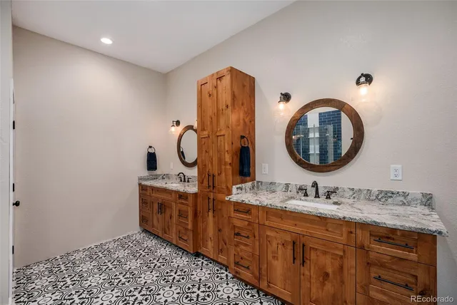 a bathroom with a double vanity sink and a mirror