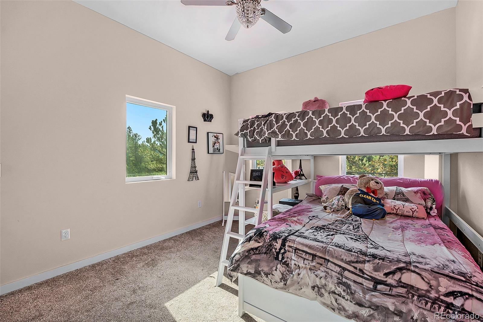 32 Oak Way Evergreen, CO 80439 - Photo 22 of 40 a bed room with a bed and a chandelier