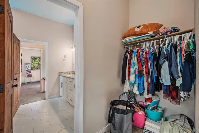 a view of walk in closet with clothes