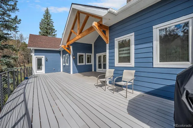 a patio with wooden floor and outdoor seating