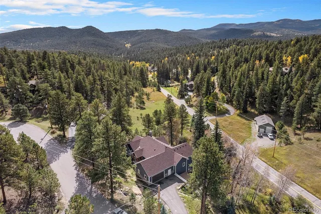 an aerial view of residential house with outdoor space and mountain view