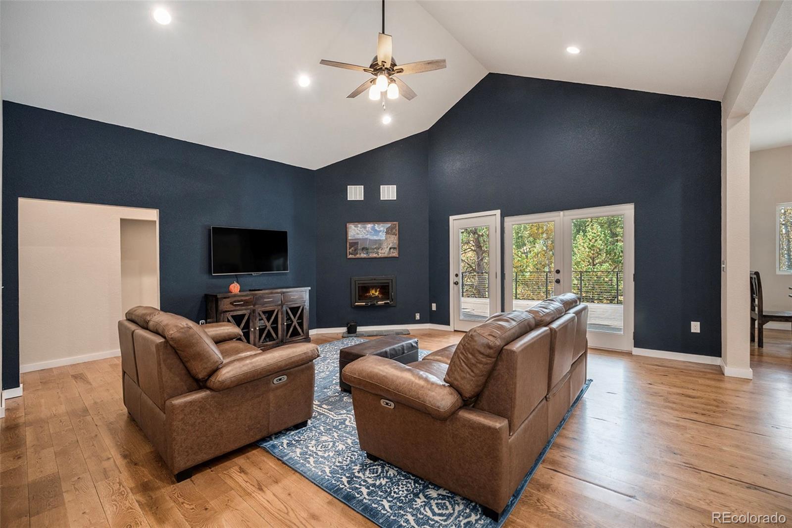 32 Oak Way Evergreen, CO 80439 - Photo 5 of 40 a living room with furniture and a flat screen tv