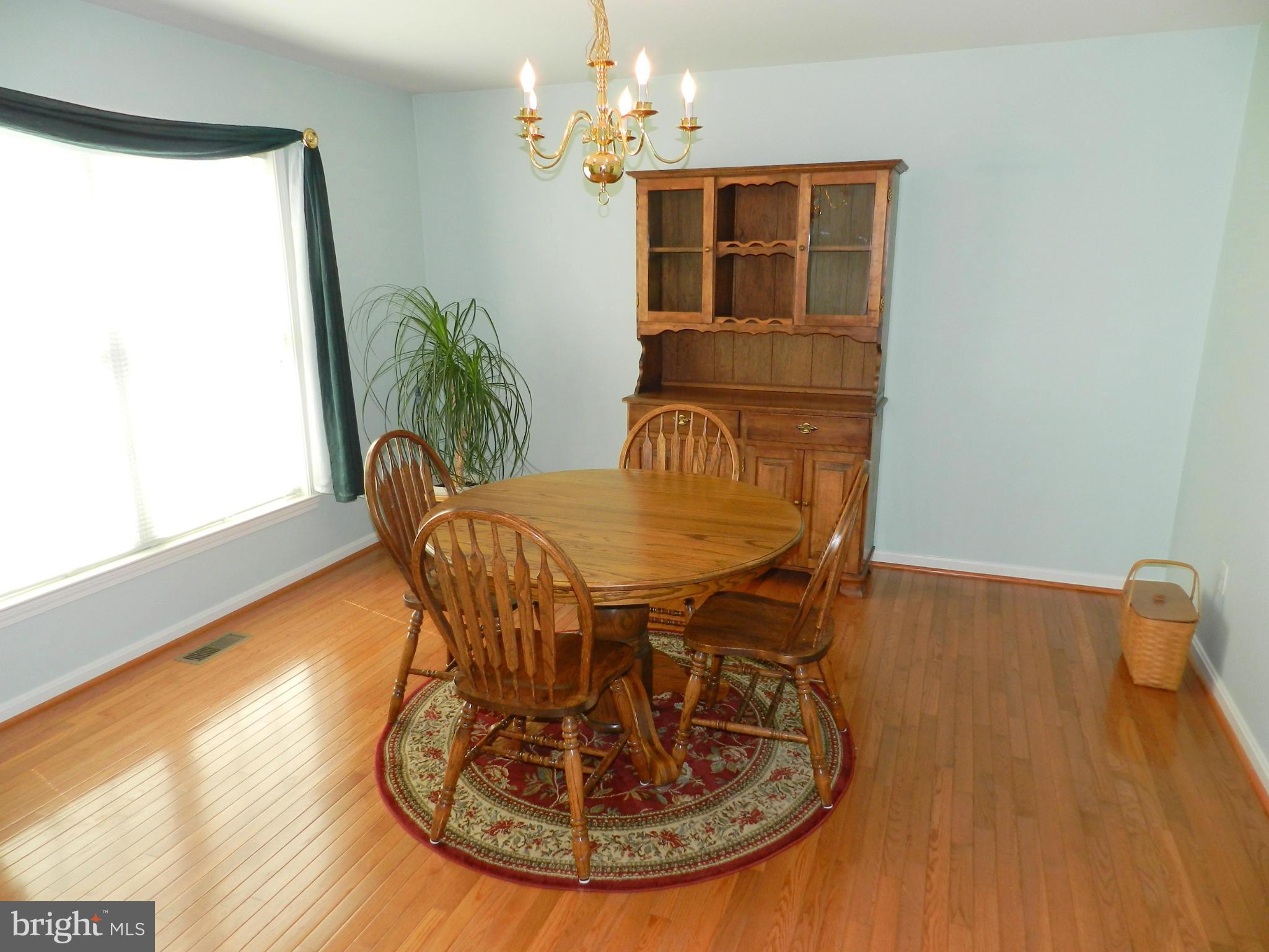 18401 Barnesville Road Barnesville, MD 20838 - Photo 11 of 30 a view of a dining room with furniture and wooden floor