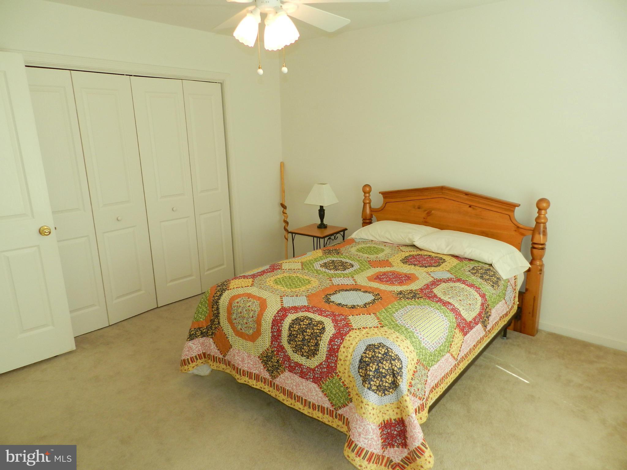 18401 Barnesville Road Barnesville, MD 20838 - Photo 19 of 30 a bedroom with a bed and a chandelier