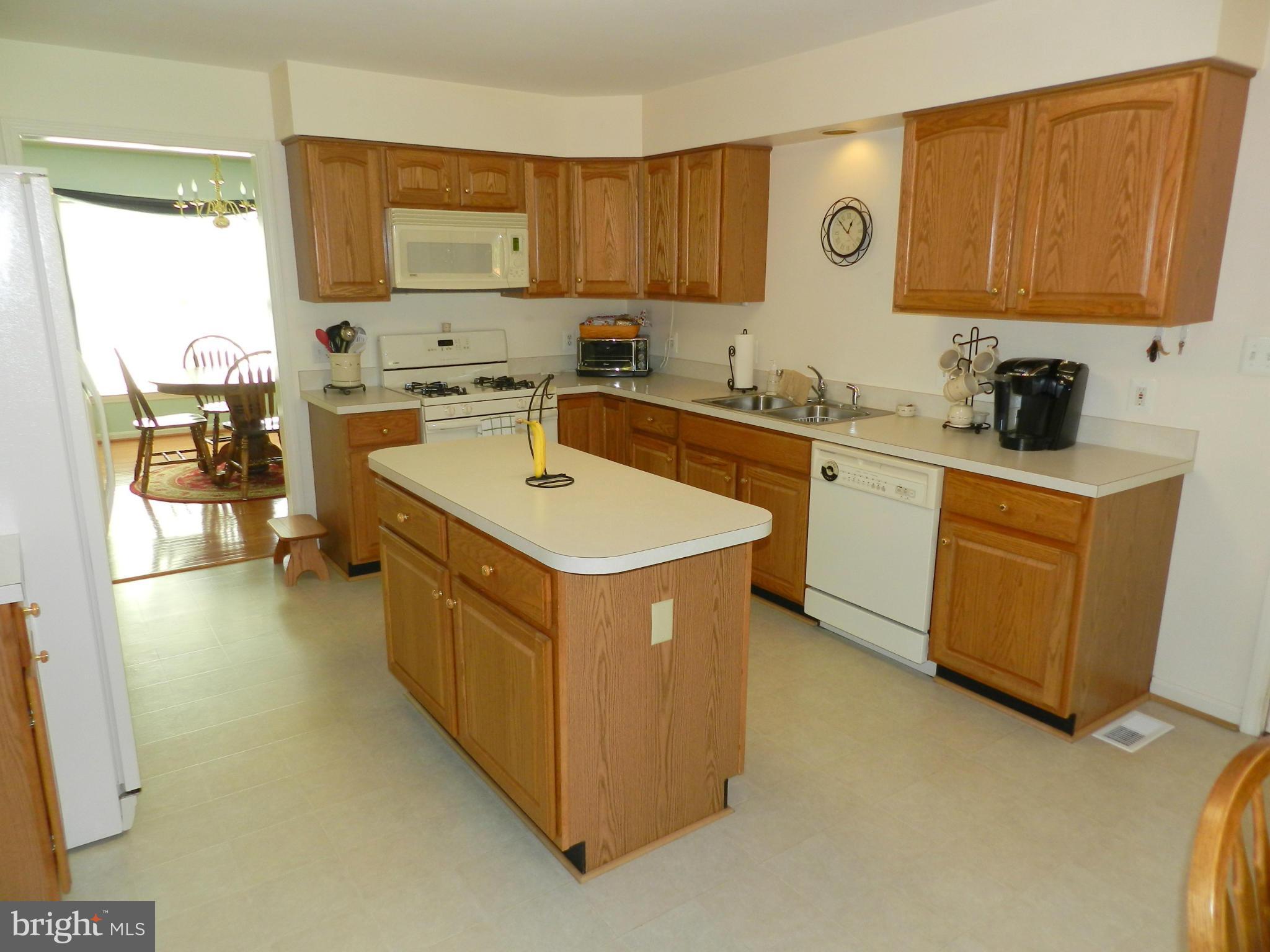 18401 Barnesville Road Barnesville, MD 20838 - Photo 8 of 30 a kitchen with a sink stove and cabinets