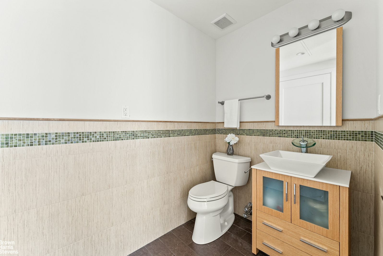 131 East 38th Street Manhattan, NY 10016 - Photo 20 of 26 a bathroom with a toilet sink and mirror